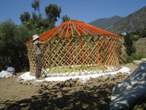Putting up our yurt frame, more challenging than it looks.
