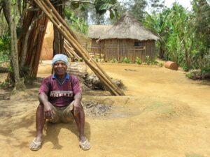 A village elder sits proud in a model village